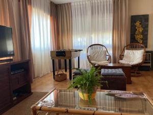 a living room with a coffee table and a tv at Casa a 2 minutos andando a la playa de Panxón in Nigrán