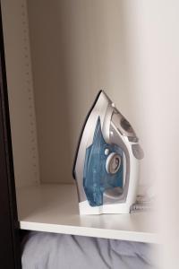 a iron on a shelf with a camera on it at Hemel Apartments- Riverside Retreat in Hemel Hempstead