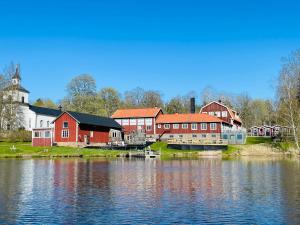 a group of buildings next to a body of water at Trehörna Wärdhus & Vandrarhem in Trehörna