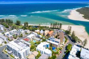 an aerial view of a beach with buildings and the ocean at Callie Beach Escape - Beachside View, Family Friendly, Walk Everywhere in Caloundra