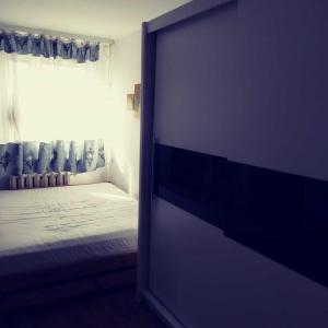 an open door to a bedroom with a bed and a window at Vip apart in Gorlice