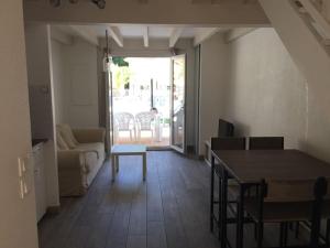 a living room with a table and a couch at T3 en duplex avec grande piscine in Anglet