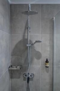 W łazience znajduje się prysznic ze szklanymi drzwiami. w obiekcie Gaia Village w mieście Tigaki