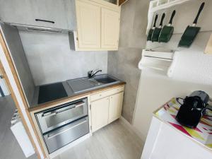 een kleine keuken met een wastafel en een fornuis bij Studio Cap d'Agde, 1 pièce, 4 personnes - FR-1-723-49 in Cap d'Agde