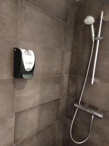 eine Dusche mit einem Haartrockner im Bad in der Unterkunft Hotel Mirtil in Pas de la Casa