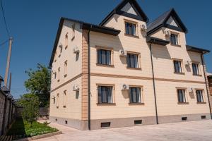 a large wooden building with windows on a street at BnB Hotel Shymkent in Shymkent