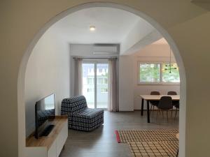 an archway in a living room with a table and chairs at MV central in Rhodes Town