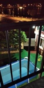 a view of a swimming pool from a balcony at night at Casa, apartment dúplex independiente in O Grove