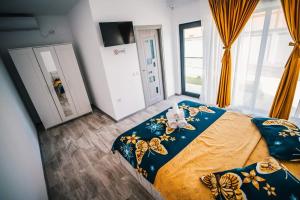 a bedroom with a bed with butterflies on it at Casutele Amaliei in Corbu