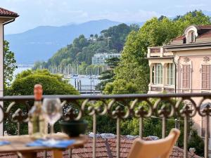 a balcony with a view of the water and buildings at La casa sul porto in Laveno-Mombello