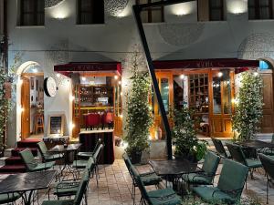 a restaurant with tables and chairs and a store at Lab City Rooms in Vlorë