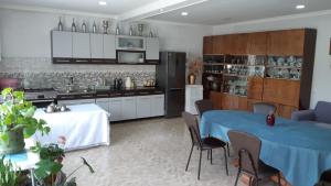 a kitchen and dining room with a table and chairs at Elegia in Arsha