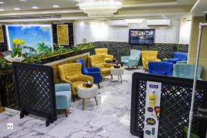 a waiting room with yellow and blue chairs at Jordan Seasons Hotel in Aqaba