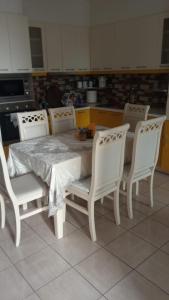 a white table and chairs in a kitchen at A&K Sea View Apartament 6 in Durrës