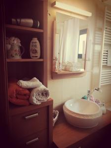 a bathroom with a sink and a mirror at Irinas country home! in Trimiklini