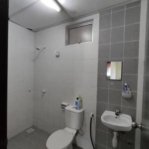 uma casa de banho com um WC e um lavatório em Homestay Nilai (Anggerik Court) em Nilai