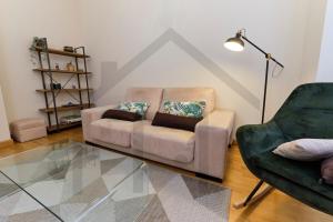 a living room with a couch and a chair at El pixin - Apartamento de gran categoría en GIJON in Gijón