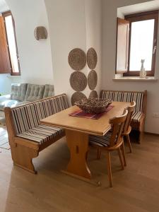 a dining room with a wooden table and chairs at La Pulchella in LʼAquila
