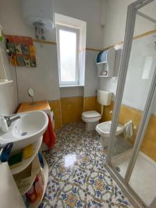 a bathroom with a toilet and a sink and a shower at Casa Franco in Ischia Town +34 photos