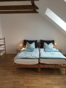 a bed with two pillows on it in a room at Ferienwohnung Modlisch in Schwarzenau