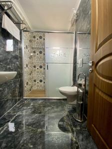 y baño con ducha, aseo y lavamanos. en Parfe Apart, en Trabzon