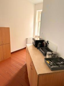 a kitchen with a counter top with a microwave at Atlas' House in Poznań
