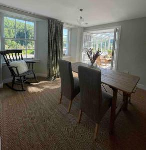 a dining room with a wooden table and chairs at Watherston Farm Cottage in Stow