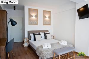 a bedroom with a bed with two towels on it at Sibiu Lotus Apartments in Sibiu