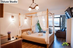 um quarto com uma cama com cortinas e uma secretária em Sibiu Lotus Apartments em Sibiu
