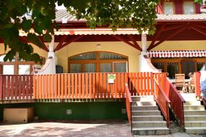 a building with a staircase in front of a house at Bremi Apartman Fonyódliget in Fonyód