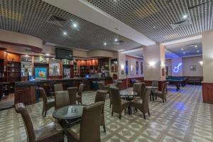 una hall con tavoli e sedie e un bar di Dexon Roma Hotel a Hurghada
