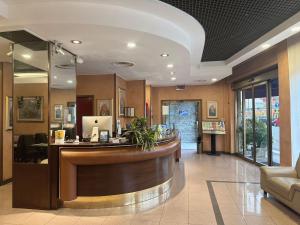 a lobby of a hospital with a reception counter at Hotel Valganna in Milan