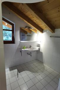 a bathroom with a sink and a window at Hotel Landhaus Zell am See in Zell am See