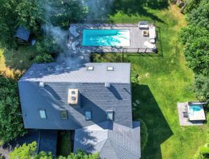 an overhead view of a house with a swimming pool at Panorama in Sainte Anne des Lacs