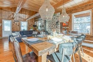 a dining room and living room with a table and chairs at River Rock Retreat in Notre-Dame-de-la-Merci