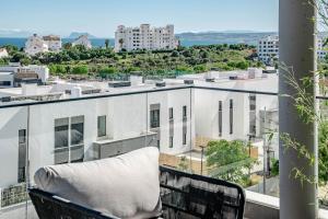a chair on a balcony with a view of a building at LME144A Spacious & luxury family home in Estepona