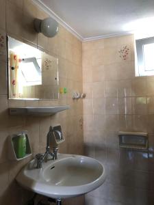 a bathroom with a sink and a mirror at THE CENTER in Xiropigado