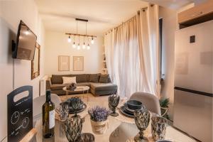 a living room with a couch and a table at Nefeli Residence in Alexandroupoli