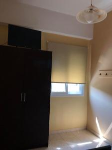 a room with a black cabinet and a window at THE CENTER in Xiropigado