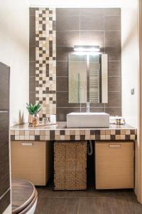 a bathroom with a sink and a mirror at Nefeli Residence in Alexandroupoli