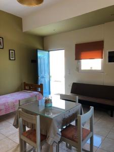 a room with two beds and a table and chairs at THE CENTER in Xiropigado