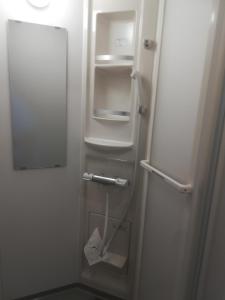 a small white refrigerator with its door open at ez guest house in Kyoto