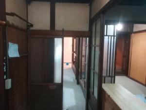 an empty room with glass doors and a hallway at ez guest house in Kyoto