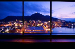 a view of a city from a window at night at La Vista Hakodate Bay in Hakodate