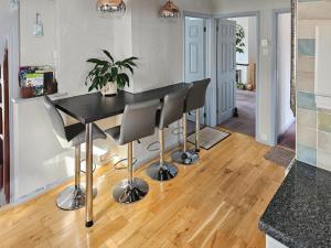 a kitchen with a black table and chairs at Moor View in Newton Abbot