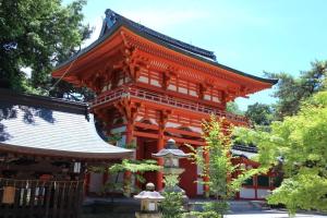 an orange building with a white roof at ez guest house in Kyoto