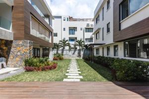 a walkway through a courtyard in a building at Modern 2 bedroom apartment - Soleia 2 Apartment A9 in Pereybere