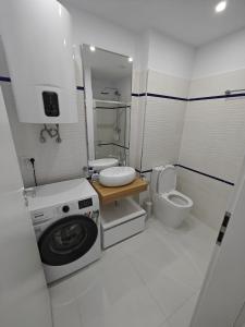a bathroom with a washing machine and a toilet at Oxygen Neptun by BOUTIQUE 23 in Jupiter
