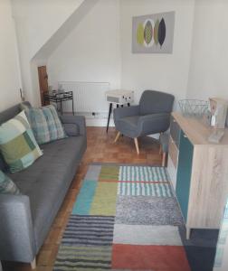 a living room with a couch and a table at Porthcawl cottage in Newton