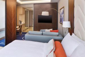 een hotelkamer met een bed en een bank bij Jeddah Marriott Hotel Madinah Road in Jeddah
